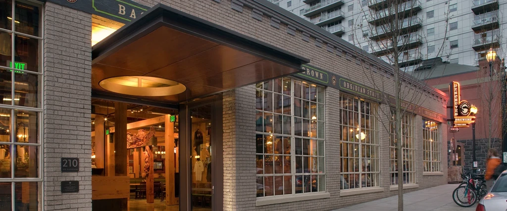 Deschutes Brewery: illuminated brick building with large windows.