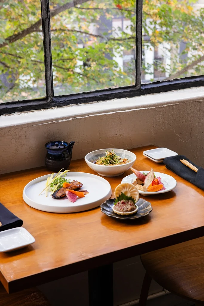 Artfully presented contemporary Asian fusion dishes on a wooden table.