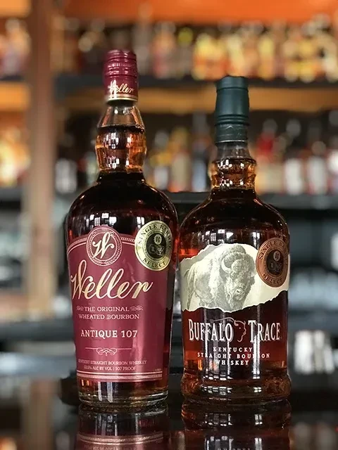 Weller Antique 107 and Buffalo Trace bourbon bottles, side-by-side.