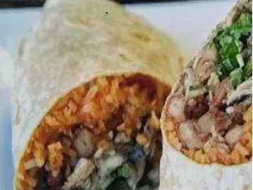 Two burritos, one sliced, revealing meat, orange rice, and green fillings.