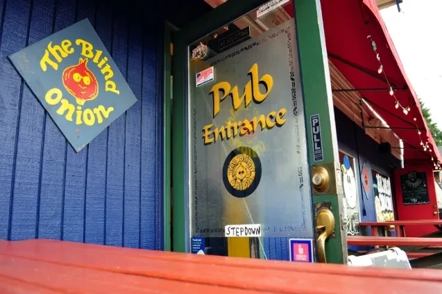 The Blind Onion pub exterior showing main entrance and cartoon onion signage.