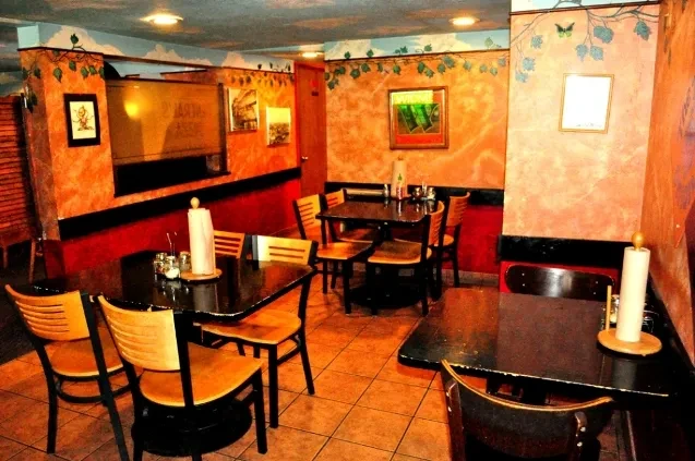 Interior of empty casual restaurant with warm walls and ceiling mural.