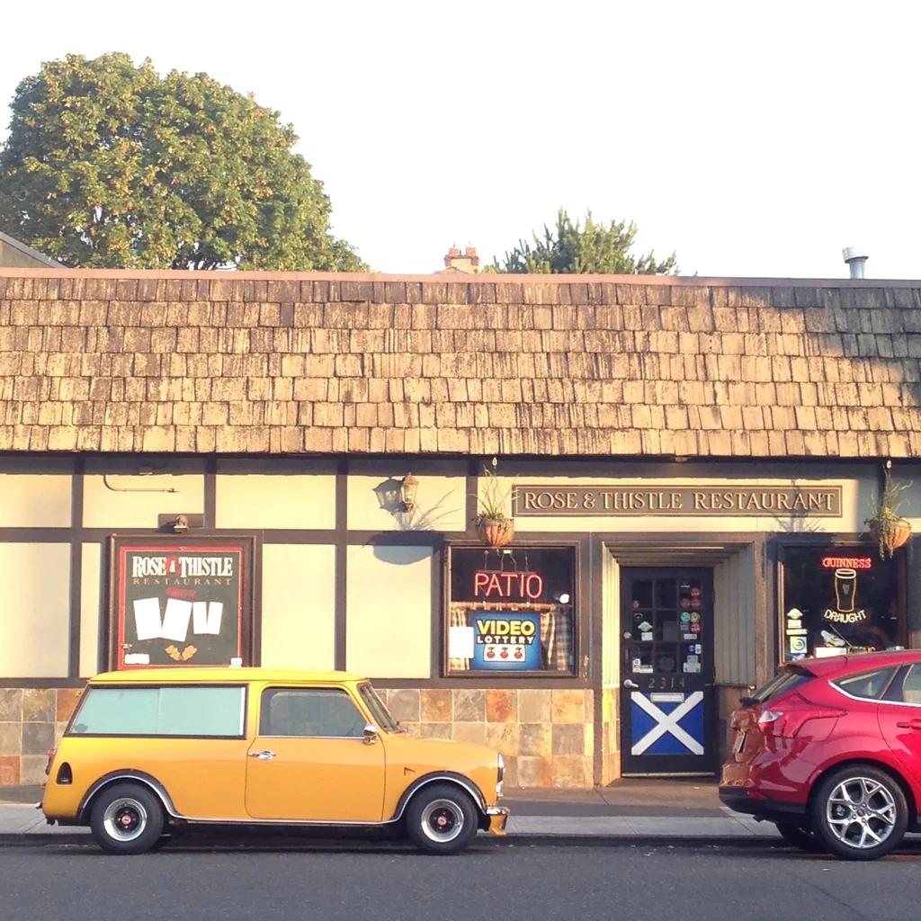 Rose & Thistle Restaurant exterior, yellow Mini and red car parked.