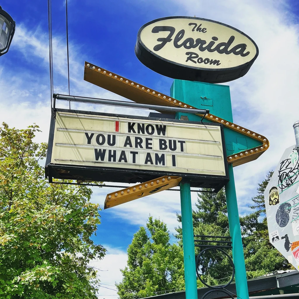 The Florida Room marquee sign: 'I KNOW YOU ARE BUT WHAT AM I'.