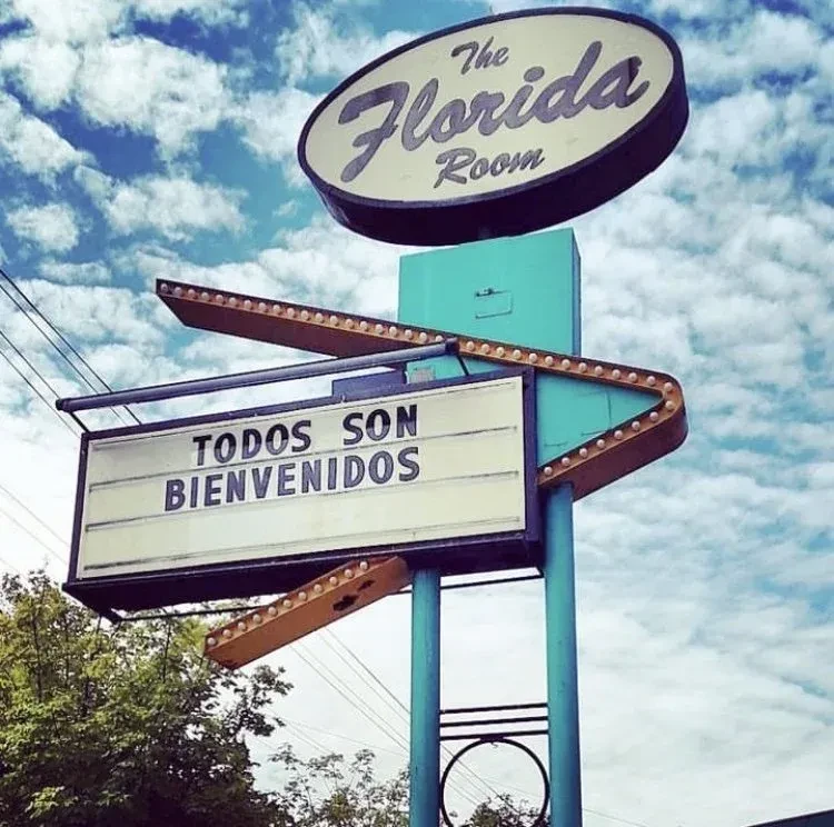 Vintage teal marquee sign for 'The Florida Room' says 'Everyone is Welcome'.
