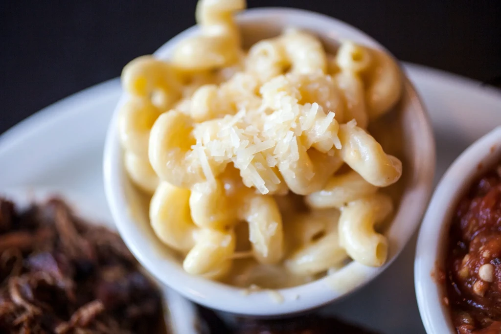 Close-up of elbow macaroni and cheese topped with shredded cheese.
