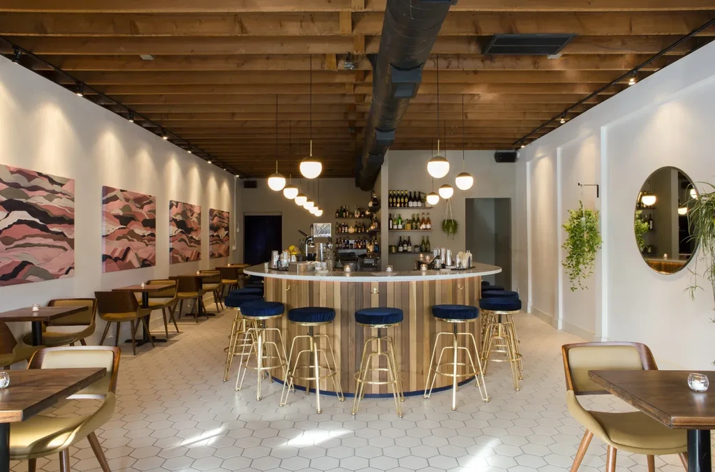 Modern restaurant interior featuring a semi-circular bar and seating areas.