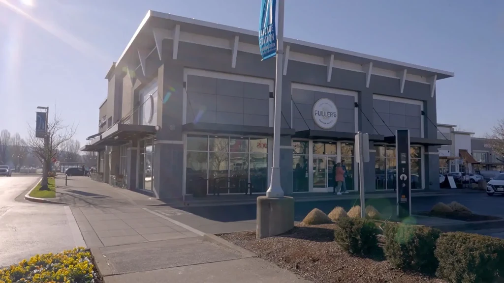 Modern Fuller's Burger Place storefront in a sunny suburban strip mall.