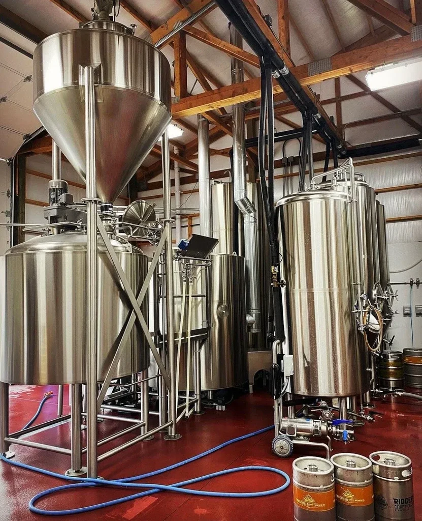 Large stainless steel brewing tanks fill a Ridgefield Craft Brewing Co. facility.