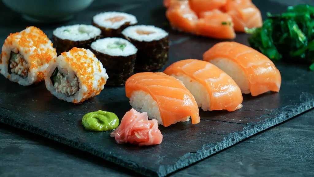 Vibrant sushi and sashimi platter with nigiri, rolls, wasabi, and ginger.