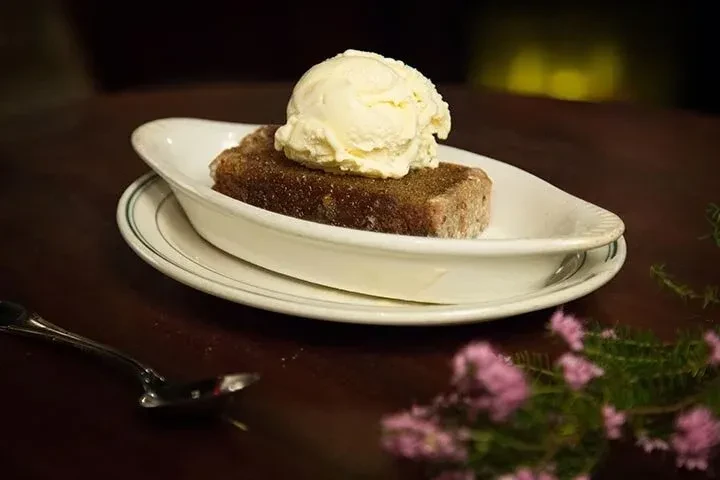 Textured baked dessert with creamy vanilla ice cream and sugar.