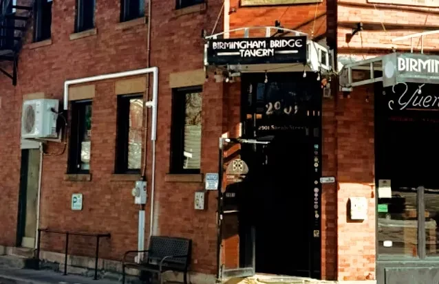 Red brick building exterior with "Birmingham Bridge Tavern" sign.