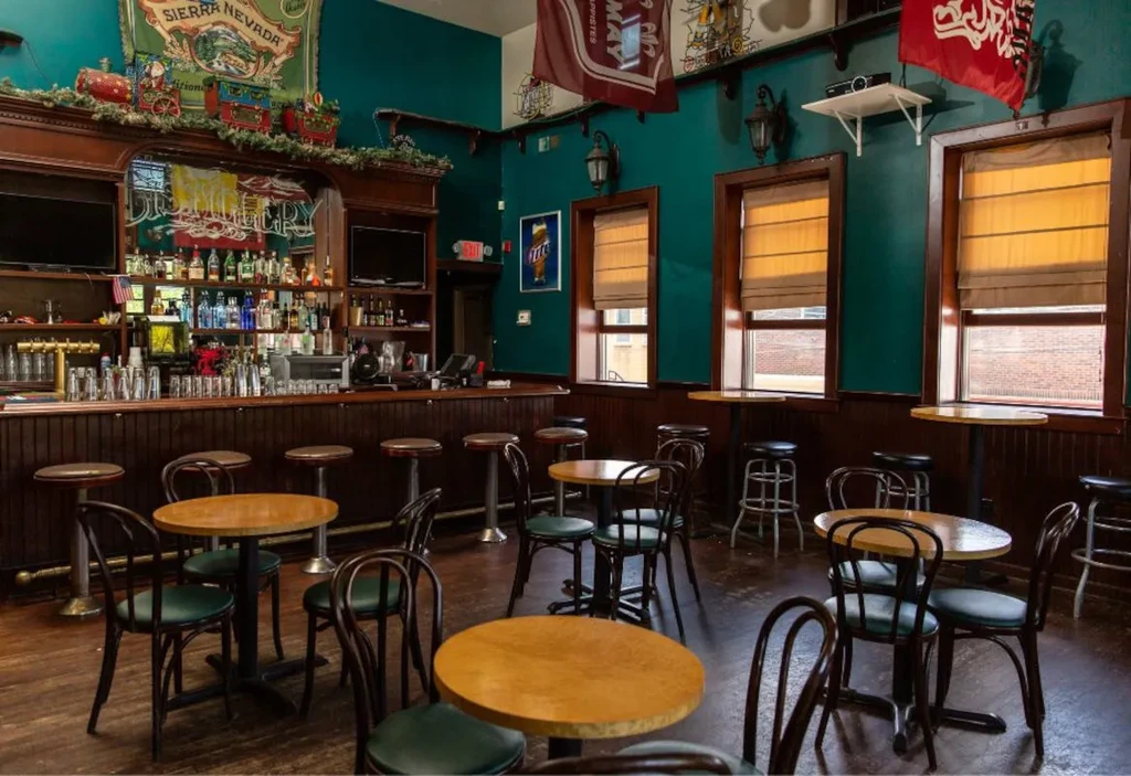 Empty rustic bar and restaurant interior with wooden bar, teal walls.