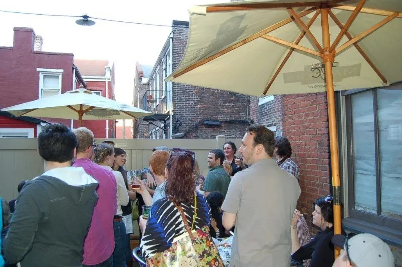 Candid snapshot of a lively group socializing at an outdoor beer garden.