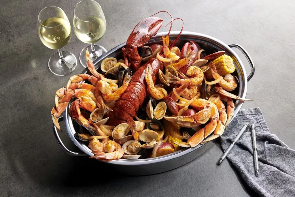 A large seasoned seafood boil with lobster, shrimp, crab, and corn.