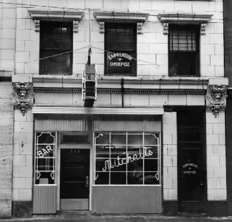 Ornate black and white building with 'BAR Mitchell's' and Greek script.