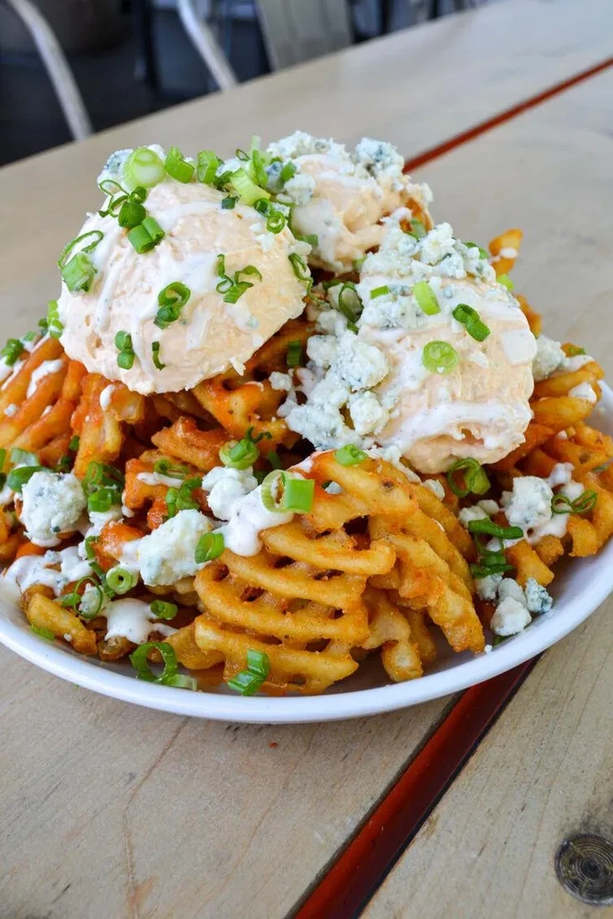 Crispy waffle fries loaded with buffalo sauce, creamy dressing, blue cheese, scallions.