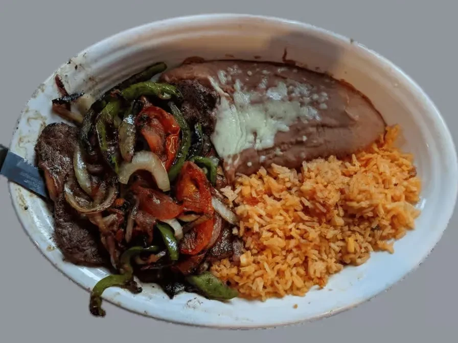 Plate with Mexican fajitas, refried beans, and orange Mexican rice.
