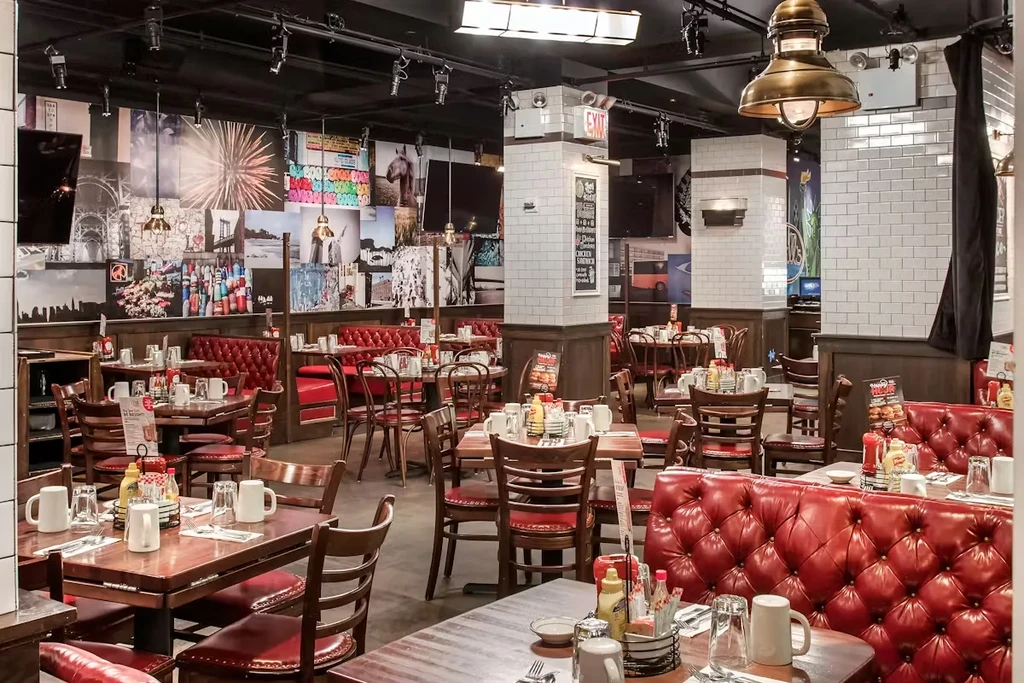 Modern industrial diner interior with red booths and eclectic decor.