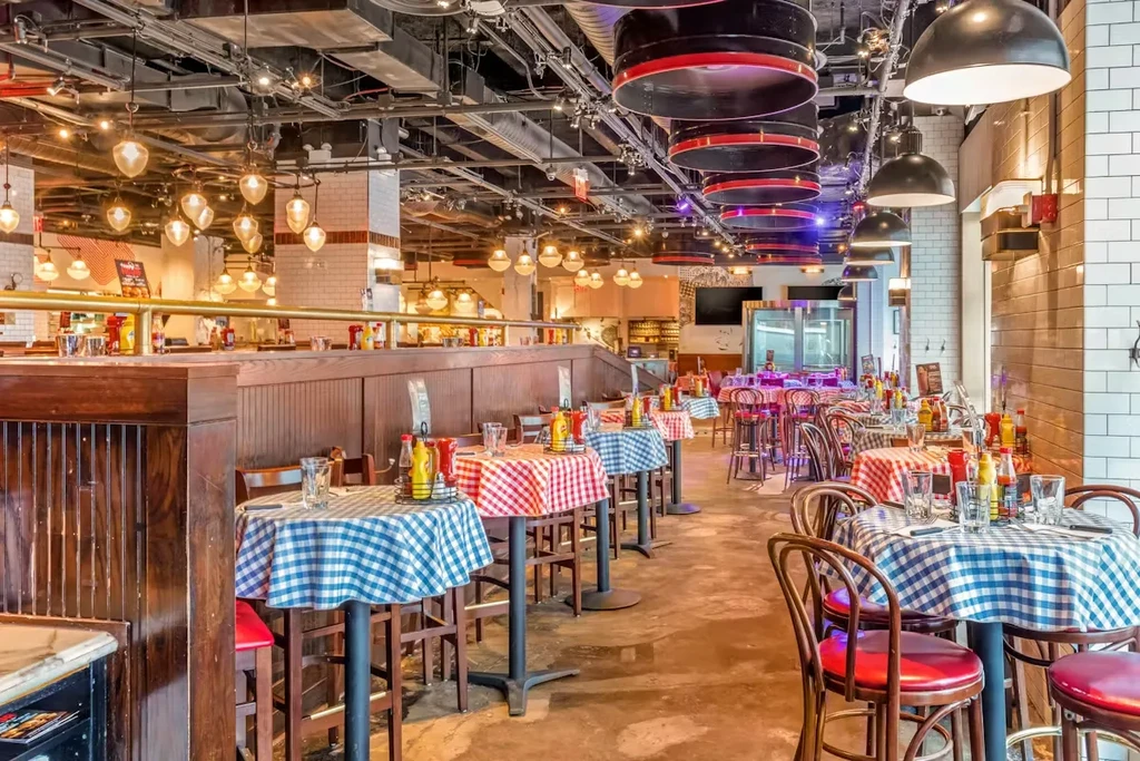Empty casual restaurant interior with checkered tables and industrial design.