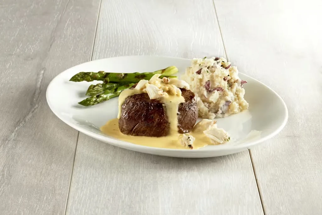 Filet mignon topped with crab sauce, asparagus, and rustic mashed potatoes.