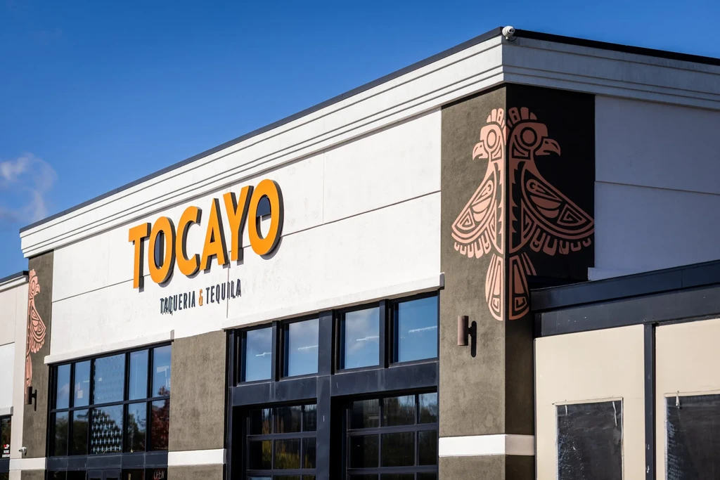 Modern 'TOCAYO Taqueria & Tequila' restaurant exterior with stylized animal murals.