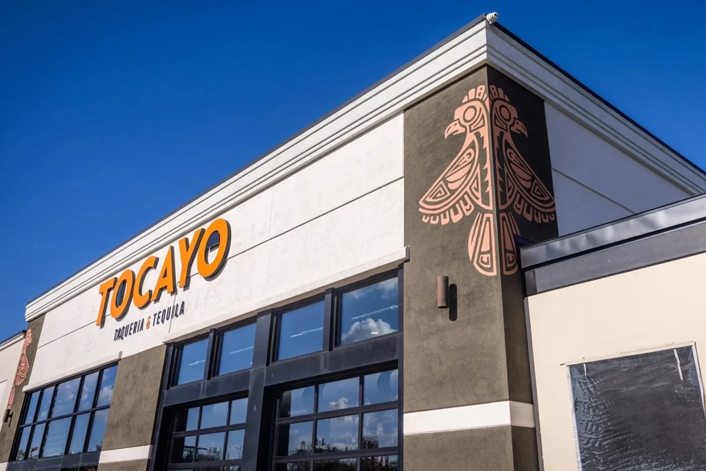 Modern Tocayo Taqueria & Tequila exterior with stylized bird mural.