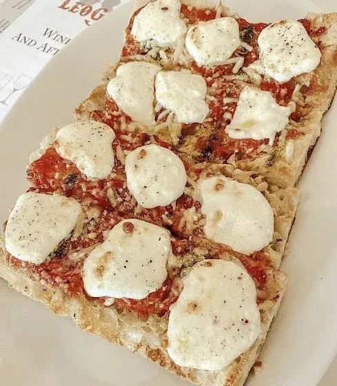 Rectangular pizza with tomato sauce, melted mozzarella, and black pepper.