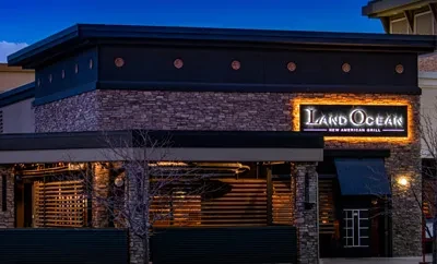 Land Ocean New American Grill exterior, dark building with glowing sign.