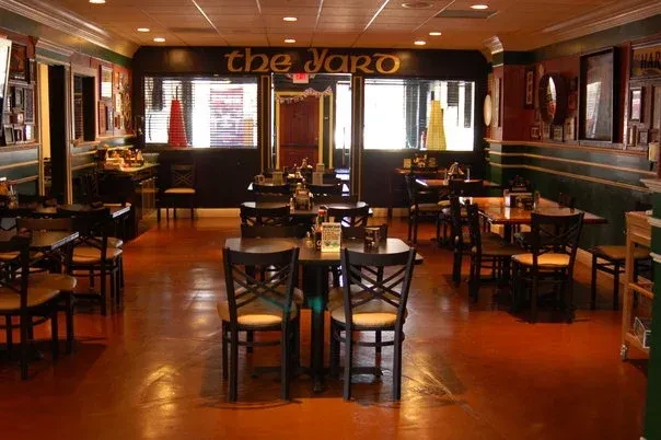 The Jaro restaurant's empty dining area with dark wood furniture.
