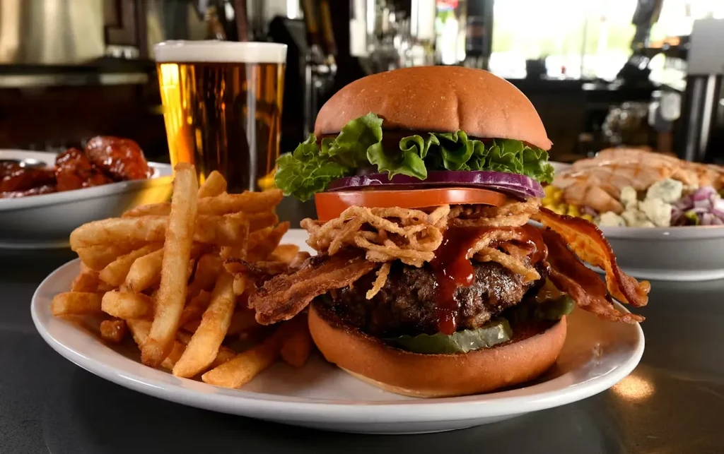 Close-up of gourmet burger, french fries, and beer in a restaurant.