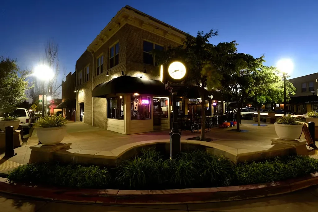 Night view of a two-story brick bar with an illuminated '101' sign.