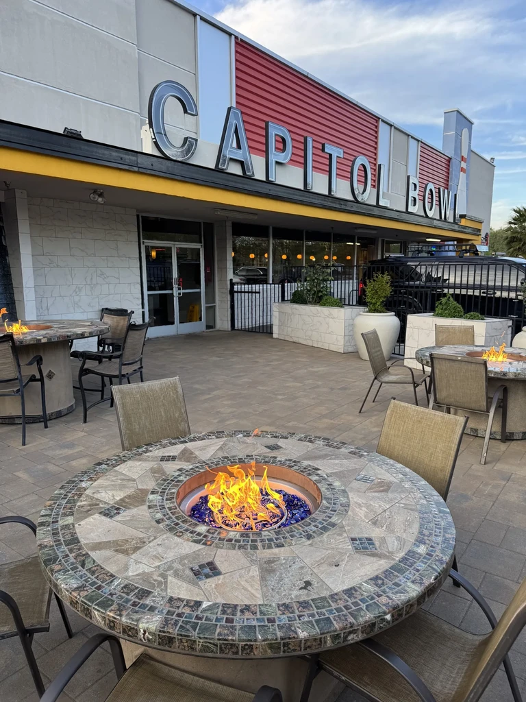 Outdoor patio with flaming mosaic fire pits outside Capitol Bowl.