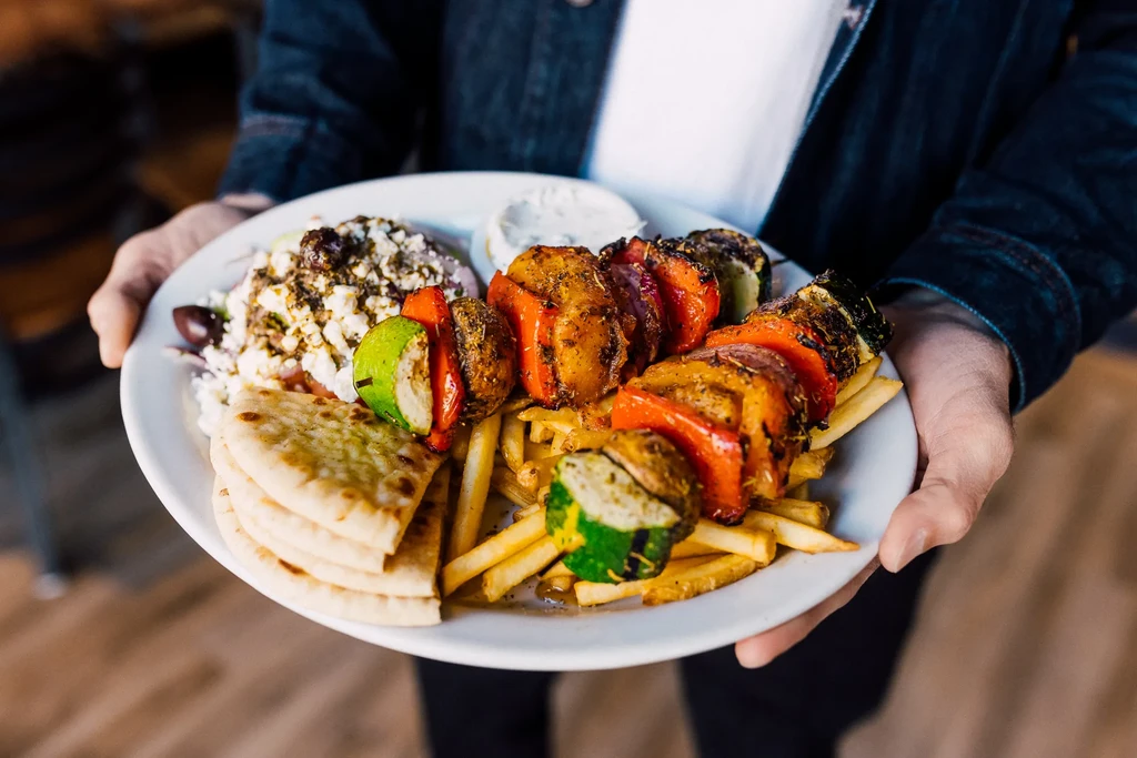 Meal: grilled vegetable skewers, french fries, Greek salad, pita, tzatziki.