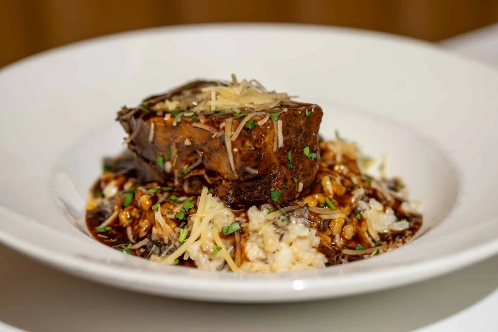Braised short rib with Parmesan, herbs, rich sauce, and risotto.