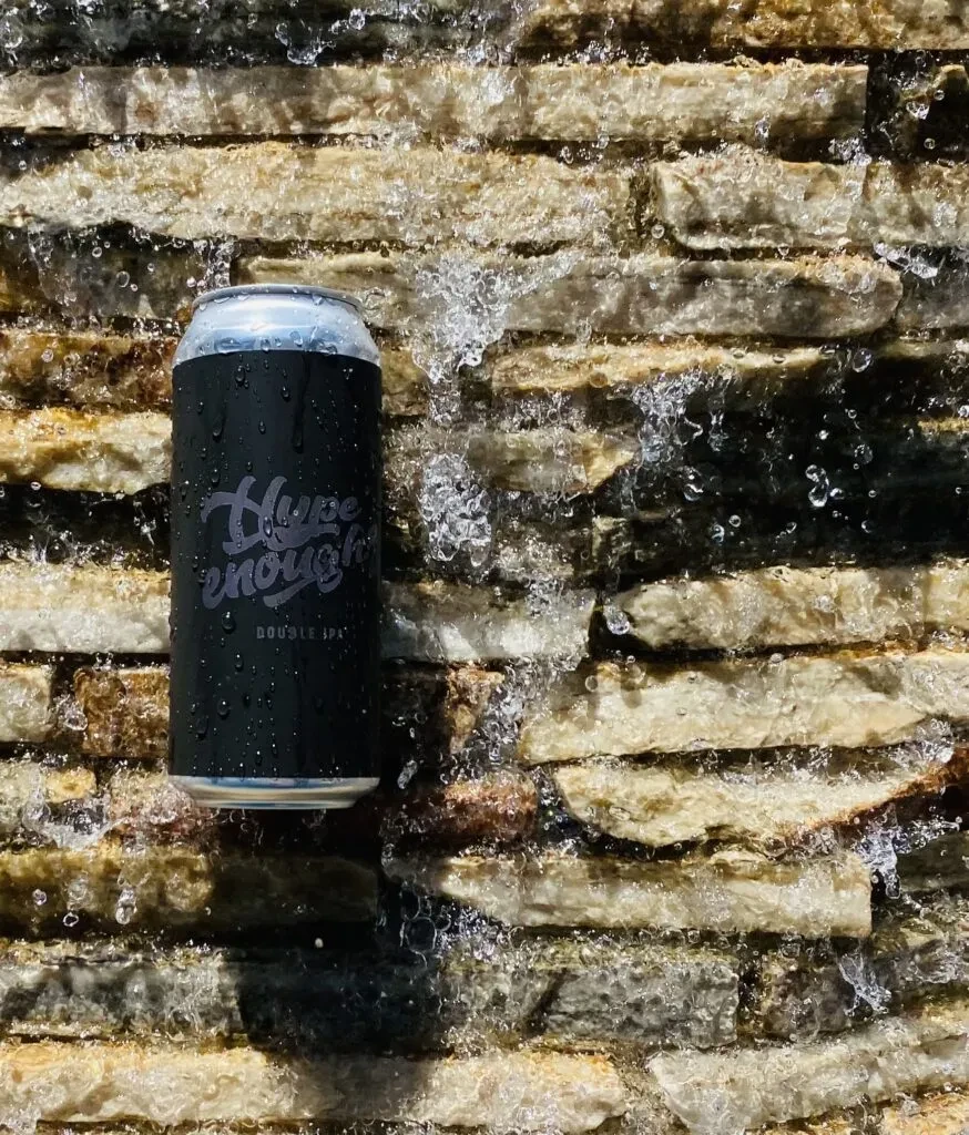 Black 'Hype enough? DOUBLE IPA' can being splashed against a stone wall.