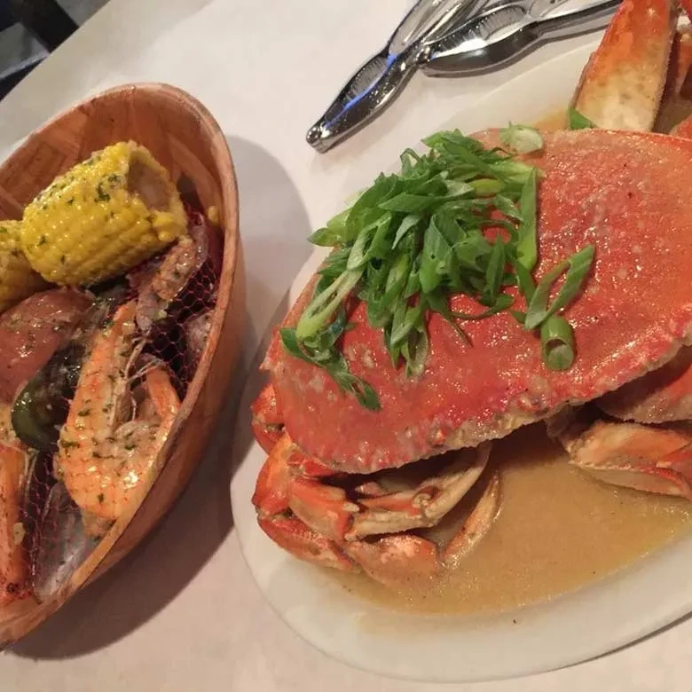 Cooked bright red crab and seafood boil, overhead view.