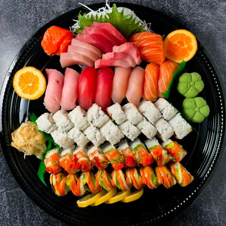 Large platter with various sushi, sashimi, and maki rolls.