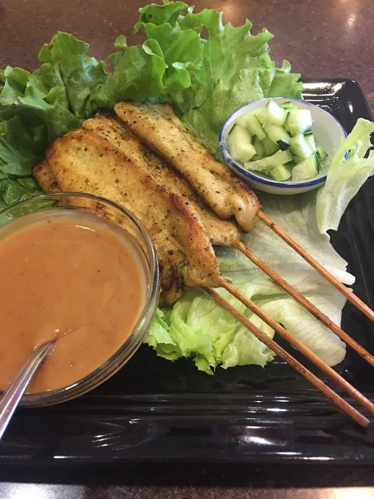 Grilled chicken satay skewers with peanut sauce and cucumber relish.