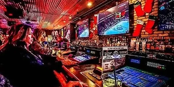Bar interior with slot machines, big screen TVs and patrons