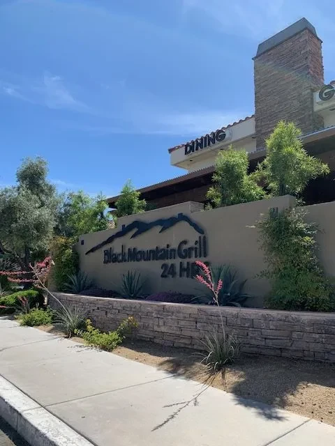 Facade of Black Mountain Grill 24 HR restaurant with sign and landscaping.