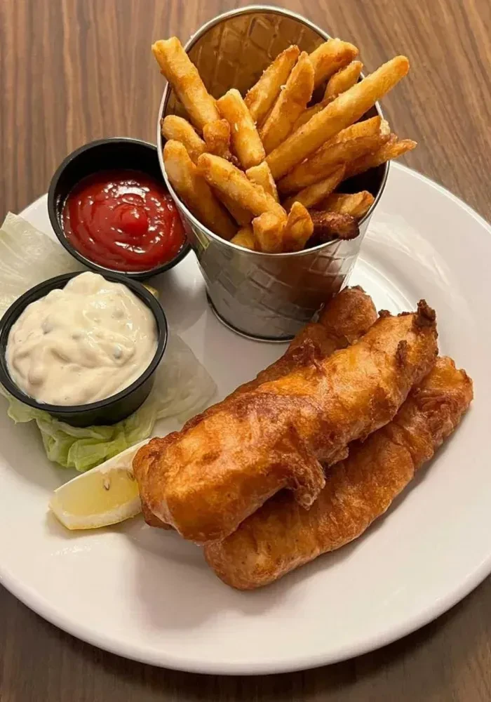 Classic fish and chips, fries, lemon, lettuce, ketchup, tartar sauce.