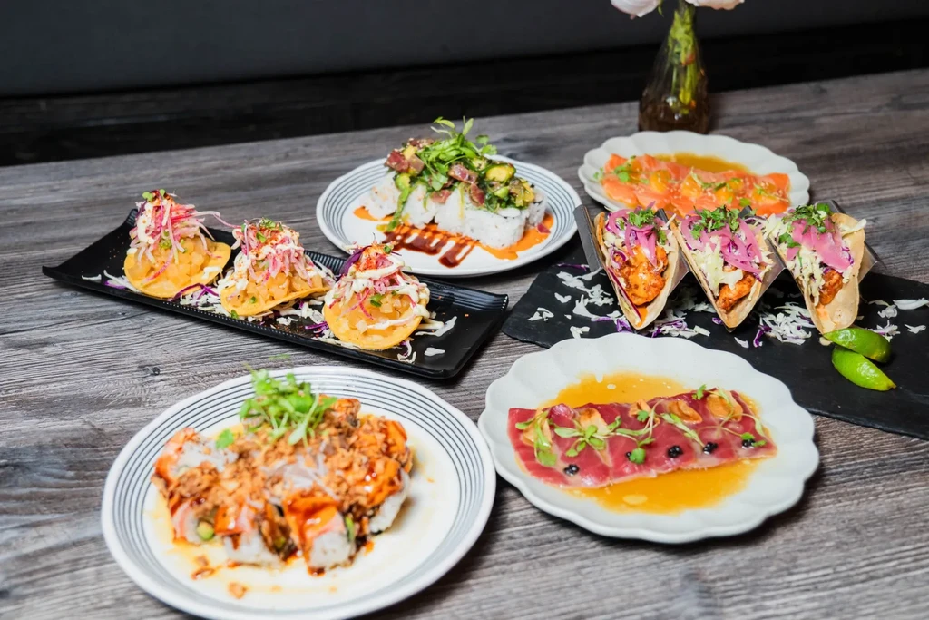 A vibrant spread of Asian and Latin-inspired sushi, tacos, and ceviche.