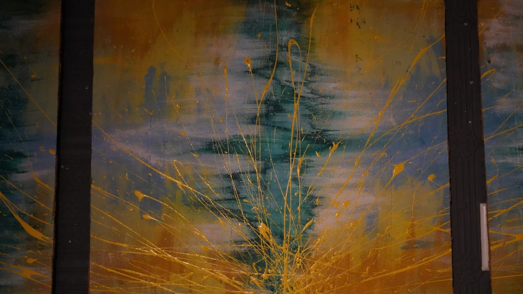 Abstract painting: teal, blue, gray with radiating yellow paint splatters.