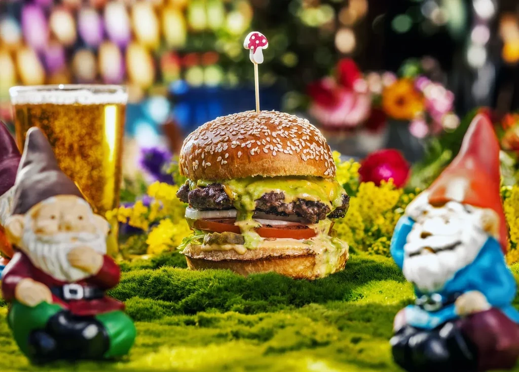 Double burger with green cheese, tomato, moss, gnomes, and a drink.