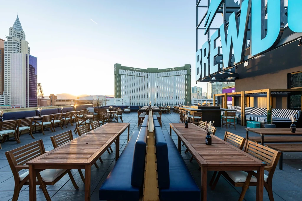 Brewdog rooftop bar overlooks Las Vegas city skyline at sunset.