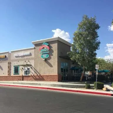Lucky's Drive Thru restaurant with green outdoor umbrellas.