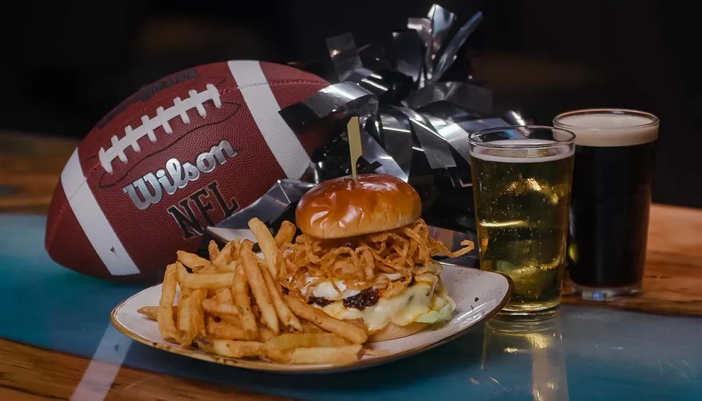 Burger, fries, two beers, and an NFL football.