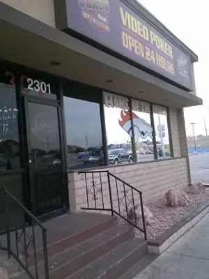 Jakes Bar & Grill building exterior with large windows and Broncos logo.