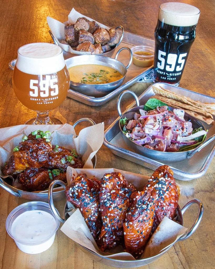 Overhead view of various appetizers and two 595 Craft Kitchen beers.